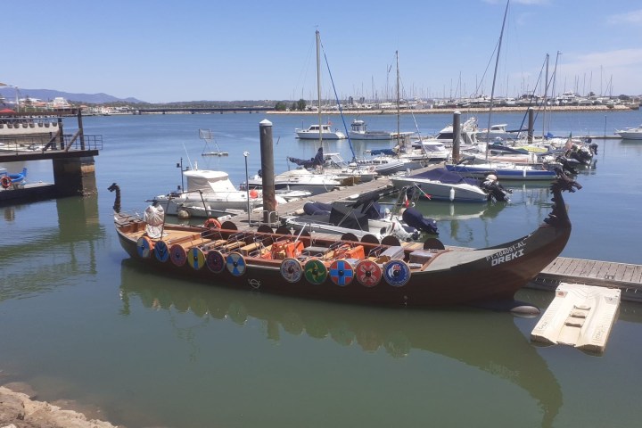 a boat is docked next to a body of water